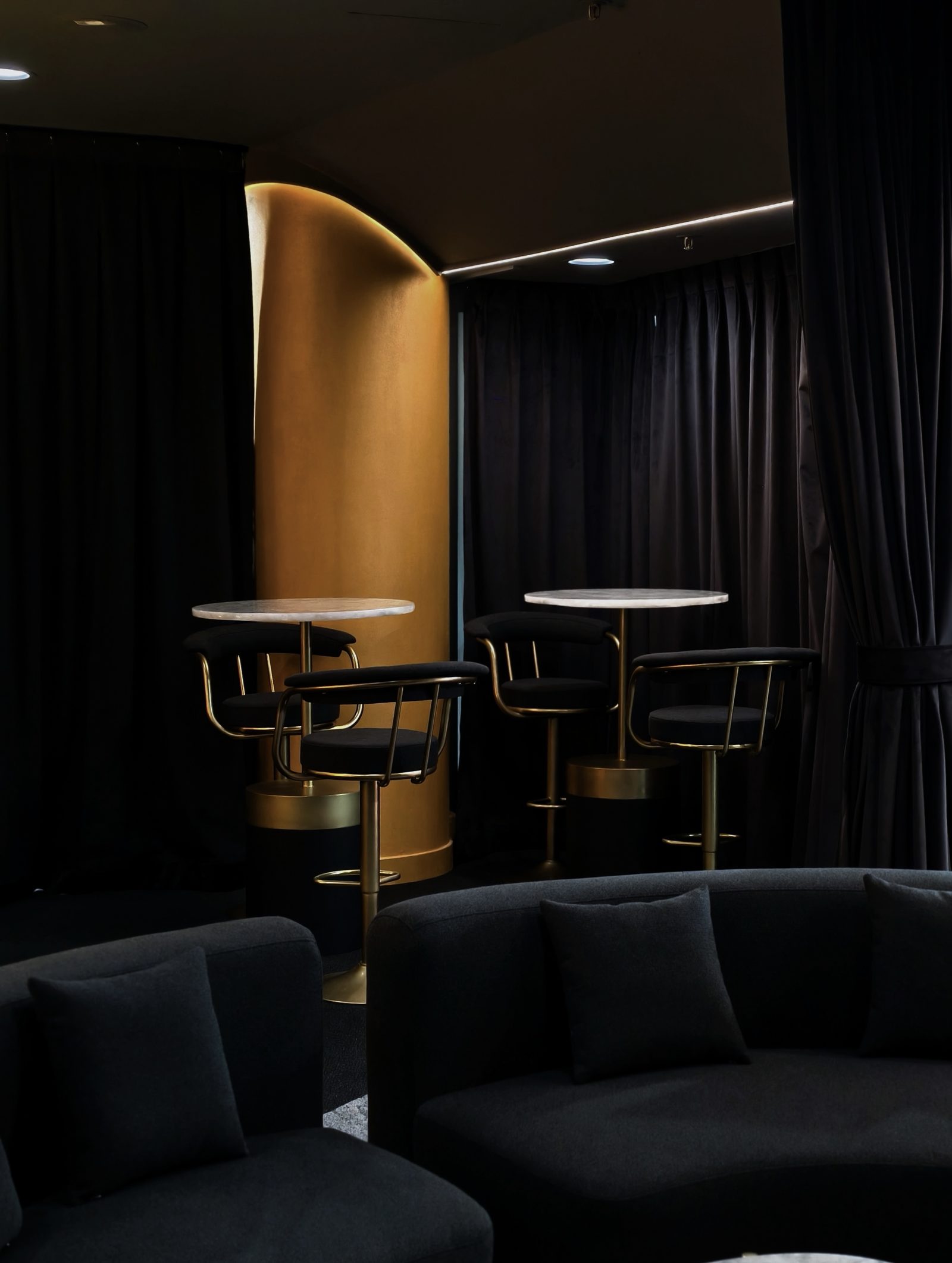 High-top bar seating beneath the gold feature pillar